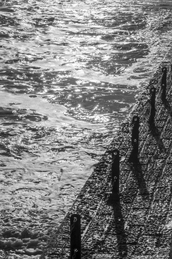 Abstract sunlight on sea with concrete Groyne and posts casting shadows, Hove black & white 2014 eyeteeth.net