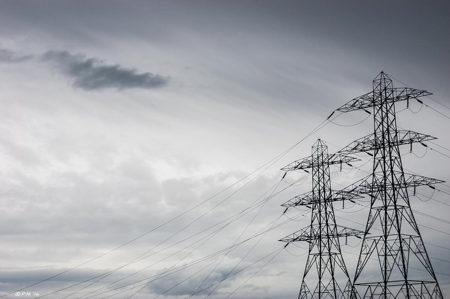 Electricity Pylons silhouetted against cloudy sky as storm passes Portslade Sussex UK 2014 eyeteeth.net