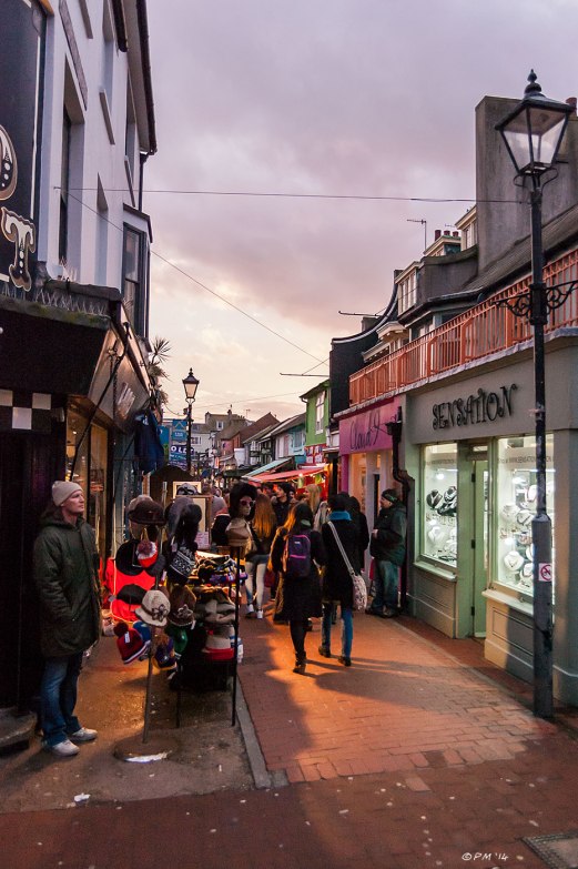 Street vendor and shoppers in Kensington Gardens in Brighton North Lain area, dusk with clouds and artificial light Brighton Street Photography 2014 eyeteeth.net
