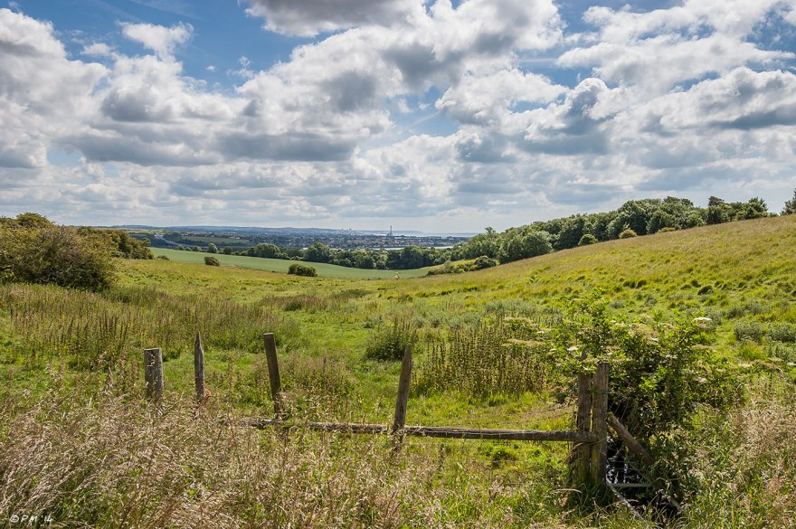 Landscape view facing east from Lancing Hill to Shoreham Power Station, Brighton and beyond, blue sky with clouds. 20114 eyeteeth.net