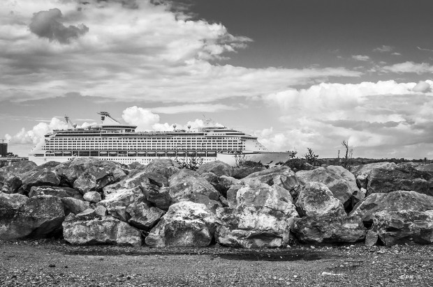 Royal Carribbean Ship Adventure on the Seas leaving port on Southampton Water shot from Hythe Marina Village with boulders in foreground Hampshire UK Monochrome Landscape. ©  P. Maton 2014 eyeteeth.net