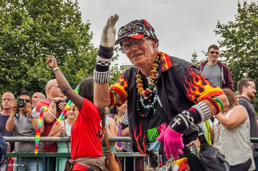 Disco Pete waves at the camera in parade at Gay Pride Brighton UK with onlookers in background P. Maton 2014