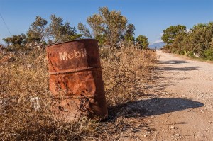Rusty Mobil oil drum in brush beside dirt road. Patara Turkey. Landscape Colour. P.Maton 2014 eyeteeth.net