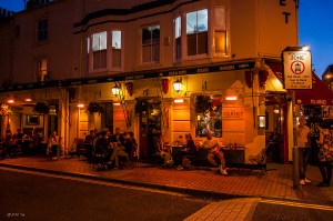 Colourful Night time view of people outside The Dorset Street Bar Gardner Street Brighton UK. Colour Landscape. © P.Maton 2014 eyeteeth.net