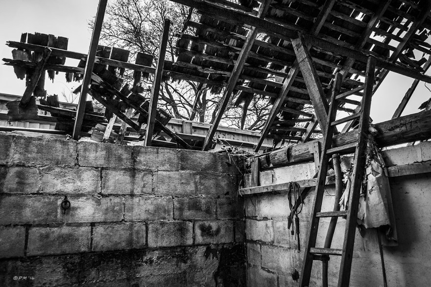 Interior with Ladder and scythe decayed walls and collapsing roof with wooden tiles abandoned stable. Ford Lane, Frilford Oxfordshire UK. Monochrome Landscape. © P. Maton 2014 eyeteeth.net