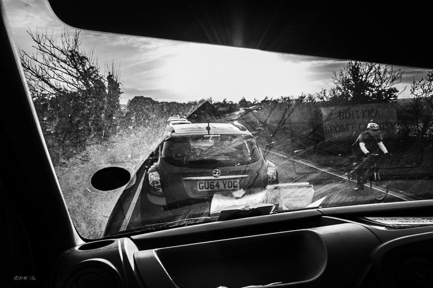 View through van window of traffic queue and passing cyclist with sun flare. Chuckler Haven East Sussex UK. Monochrome Landscape. © P. Maton 2015 eyeteeth.net