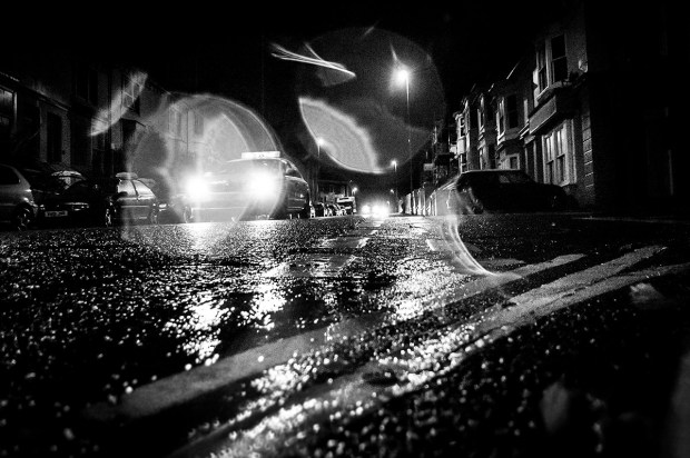 Taxi in the rain at night with water drops on lens shot from low angle. Chatham Place Brighton UK. Monochrome Landscape. © P. Maton 2015 eyeteeth.net