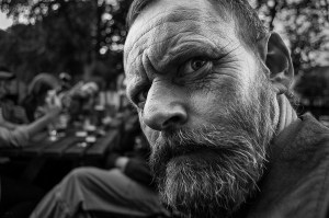 Man with beard staring into cameral while frowning. Twilight portrait black and white photograph. Brighton UK. © P. Maton 2016 eyeteeth.net