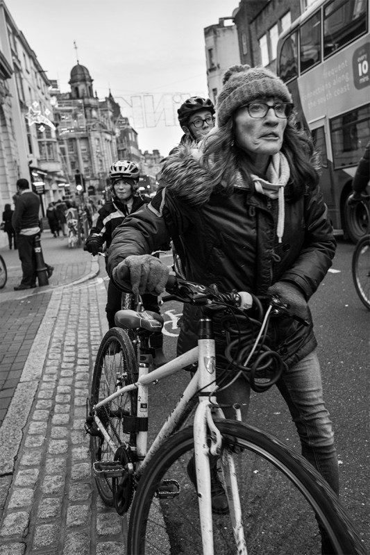 woman pushing bicycle on North Street Brighton UK street photography. Black and white portrait. © P. Maton 2016 eyeteeth.net