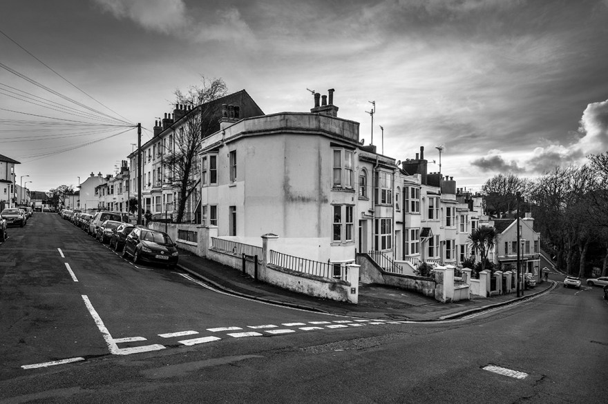 Street corner with terraced houses and  view down roads, early evening sky. Urban documentary landscape photography Howard Place Brighton UK. © P Maton 2017 eyeteeth.net