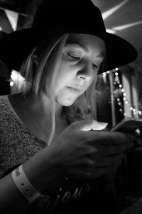Young woman in bar illuminated by light from mobile phone. Shakespeare's Head pub Brighton UK black and white nightlife portrait fujifilm XT-2 © P. Maton 2017 eyeteeth.net